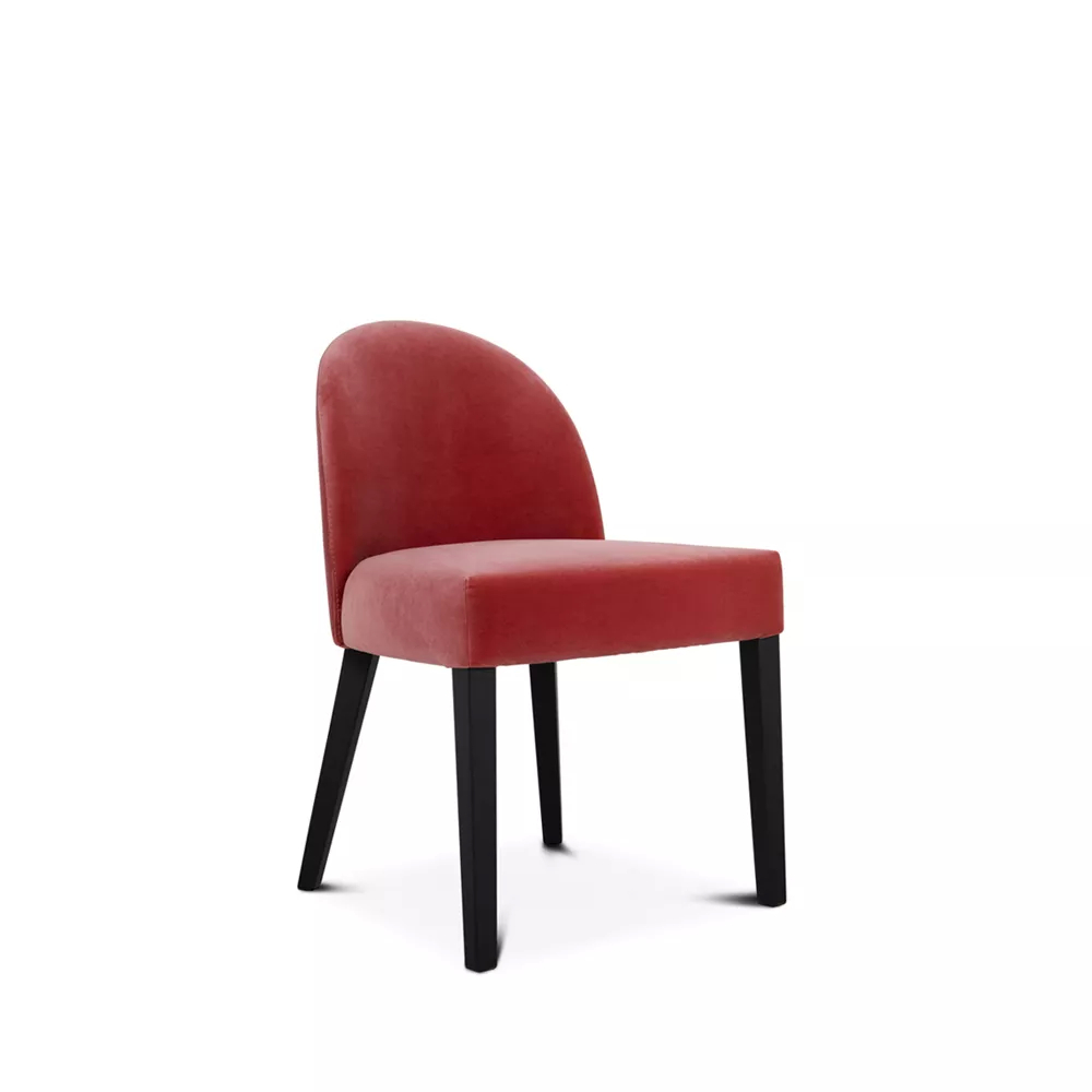 Dining chair with arched back and soft seat, upholstered in orange tone, and black base with matte finish.